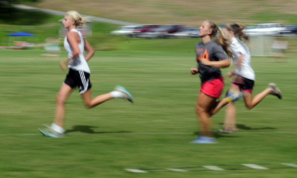 Staff photo by Joe Phelan 
 Monmouth girls soccer players run laps around the field for conditioning at the end of an Aug. 16 preseason practice. The Mustangs are off to another strong start.