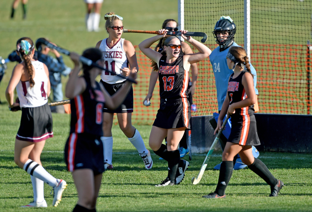 Gardiner's Hailee Lovely (13) holds her stick over her head as she waits for the official word on her goal against Maine Central Institute on Thursday in Pittsfield.