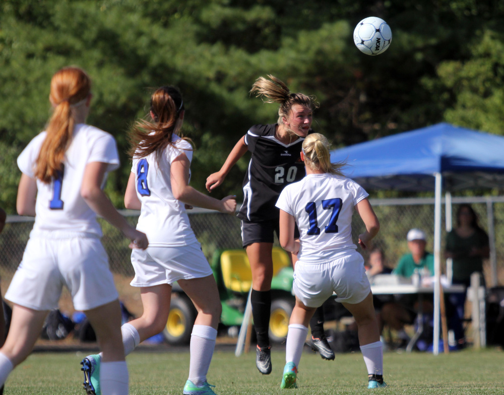 Winslow's Kate Larsen goes up for a headball near midfield against Erskine on Saturday in South China. From left to right are Erskine's Summer Hotham (1), Annemarie Allen (8) and Taylor McLaggan (17).