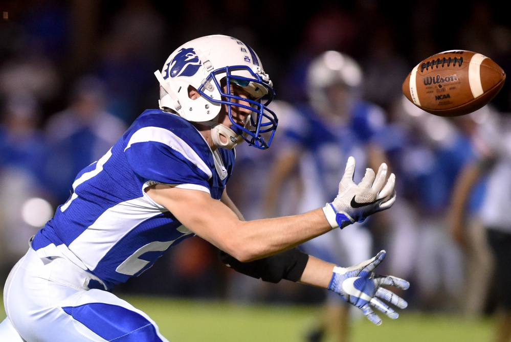 Madison receiver Sean Whalen gets his finger tips on a pass for the reception during Big Ten Conference game against Winslow on Friday night.