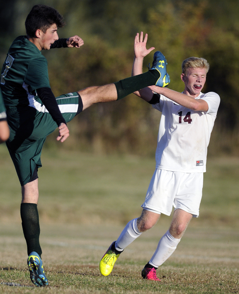 Richmond's Brendan Emmons, right, avoids a kick by Rangeley's Fletcher DellaValle on Tuesday in Richmond.