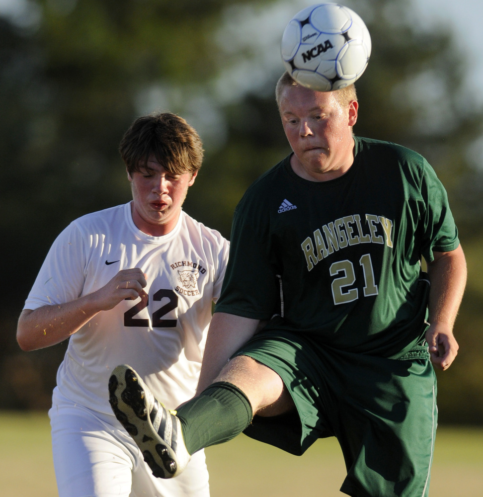 Richmond's Mason Blake, left, plays defense on Rangeley's Carl Trafton during a game Tuesday in Richmond.