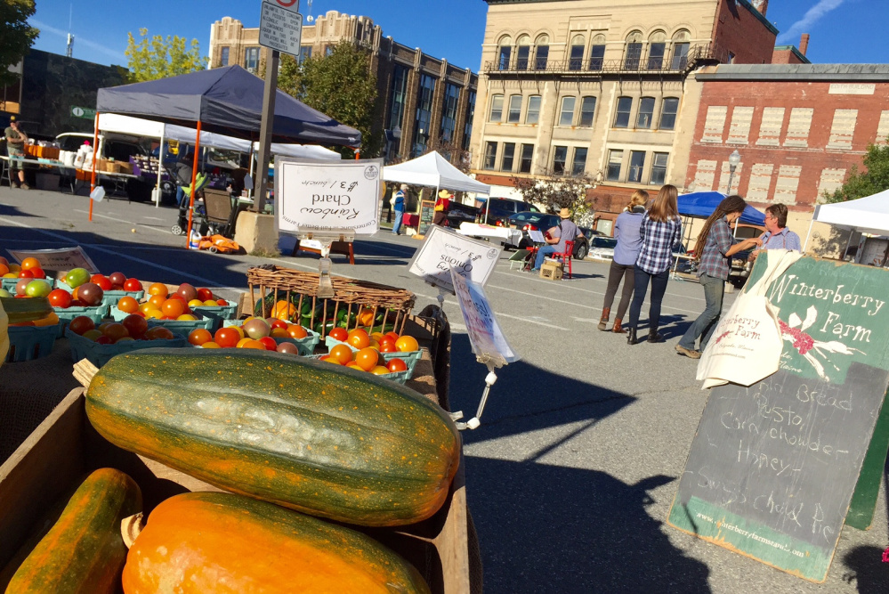 People walk around the Downtown Waterville Farmers Market on Thursday afternoon in The Concourse. The market will move to Castonguay Square next year, and Colby College plans to start construction of a new student housing building in a spot at The Concourse, where the market now is held on Thursdays.