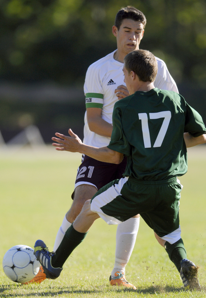 Monmouth's Travis Hartford (21) runs into Carrabec's Jared Daigle during a soccer game Thursday in Monmouth.