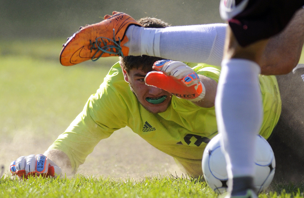 Monmouth's Avery Pomerleau shoots as Carrabec goalie Seth Padelford attempts to block the shot Thursday in Monmouth.