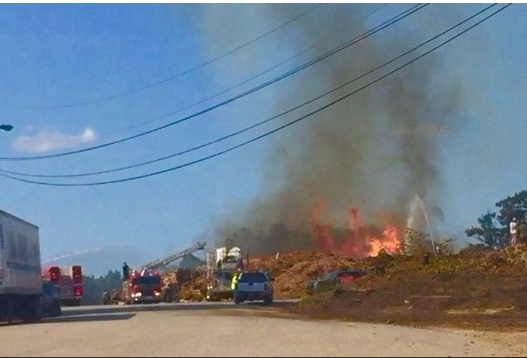 A helicopter dumps water onto a flaming pile of wood chips to help firefighters on the ground at Oldcastle Lawn and Garden in Poland on Sunday.
Photo courtesy of WSCH 6 