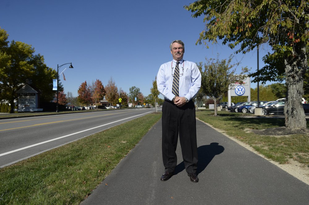 "I'm all for freedom of speech," said Peter Sowles, a co-owner of Morong Falmouth, "but I should have the right not to promote any candidate as a business." He spoke to police after removing signs in front of his dealership.