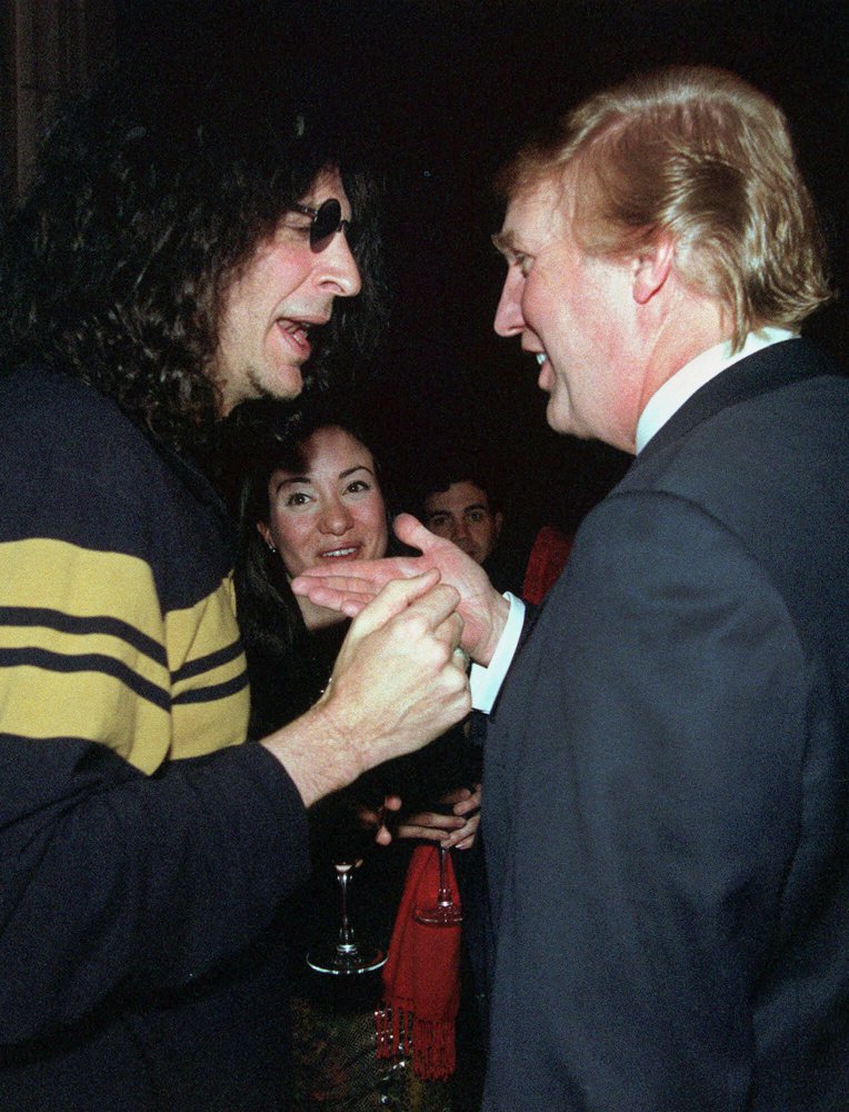 Broadcast personality Howard Stern, left, speaks with casino owner and possible presidential candidate Donald Trump at a party given by the New York Post, Wednesday, Feb. 9, 2000, in New York. (AP Photo/Louis Lanzano)