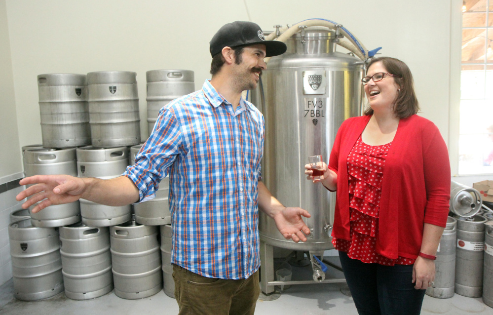 Democrat Emily Cain chats with Norway Brewing Co. co-owner Magne Melhus while campaigning Aug. 26 in Oxford County.