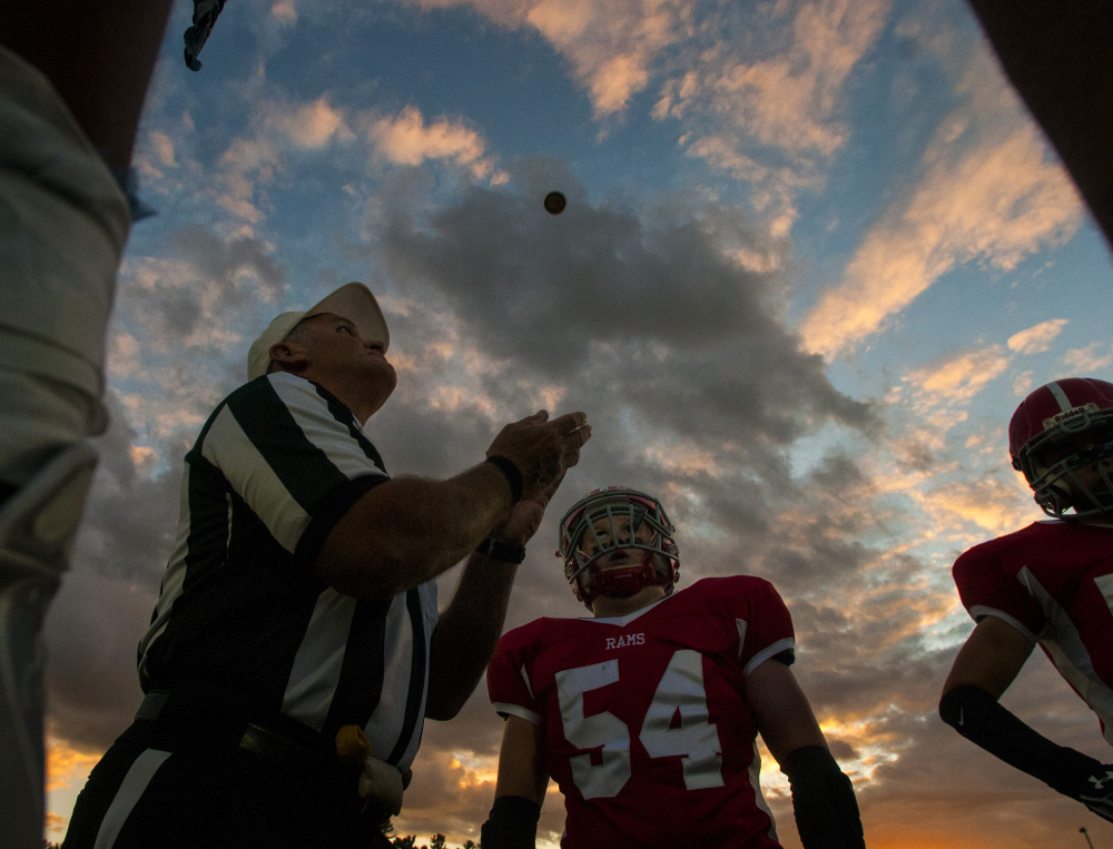 Staff file photo by Joe Phelan 
 Referee Jerry Norton prepares to catch a tossed coin at Alumni Field in Augusta prior to the start of a game betwee Mt. Blue and Cony last month. The Cougars and Rams are fighting for a playoff berth in ultra-competitive Pine Tree Conference Class B.