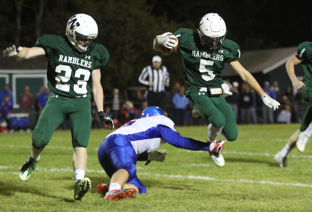 Winthrop/Monmouth's Nate Scott gets tripped up by Oak Hill High School's Austin Noble as Dylan Boyton (23) looks on during first-half action last Friday night in Winthrop.