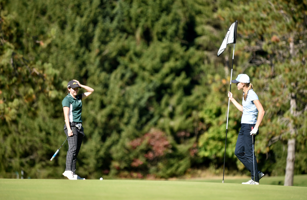 Carrabec's Katie Dixon, left reacts after missing a putt on the ninth hole during the Mountain Valley Conference qualifier Wednesday at Natanis Golf Course in Vassalboro.