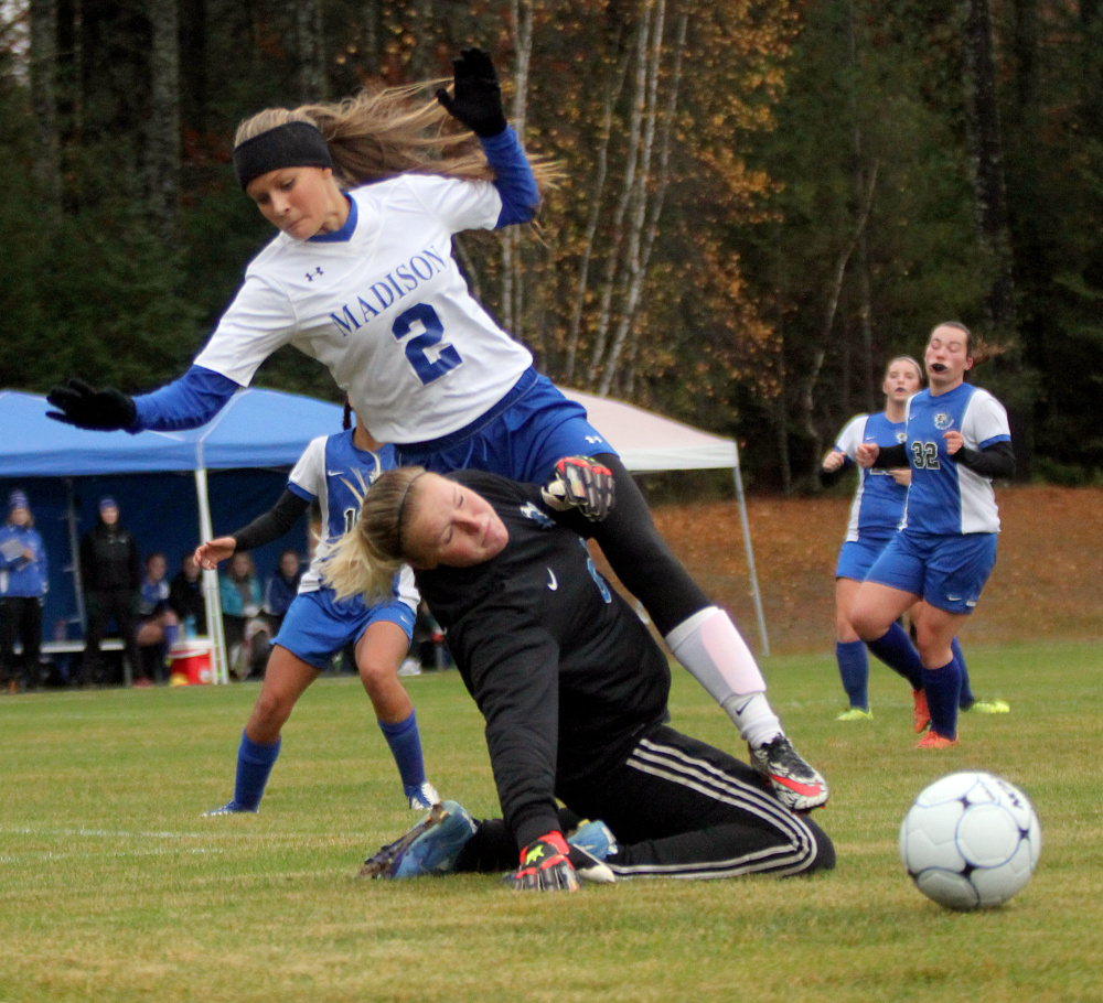 Madison's Jillian Holden collides with Sacopee goalie Madison Day in the first half of a Class C South girls soccer semifinal in Madison on Saturday. Madison won 1-0.