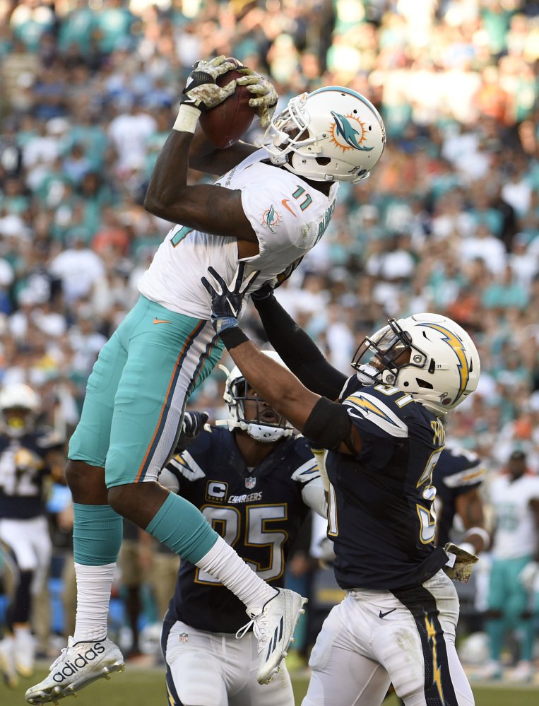 Miami Dolphins wide receiver DeVante Parker catches a pass over San Diego Chargers strong safety Adrian Phillips during the second half of an NFL football game in San Diego, Sunday. Associated Press/Denis Poroy