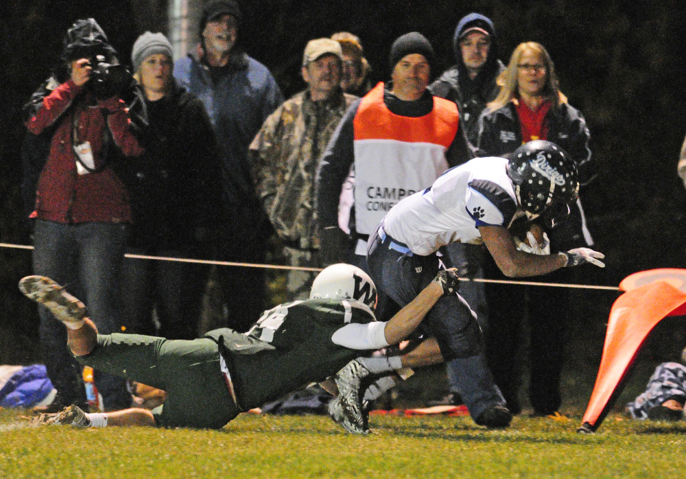 Winthrop's Bennett Brooks, left, tackles Dirogo's Hunter White during a Campbell Conference Class D semifinal game last Friday at Maxwell Field in Winthrop.