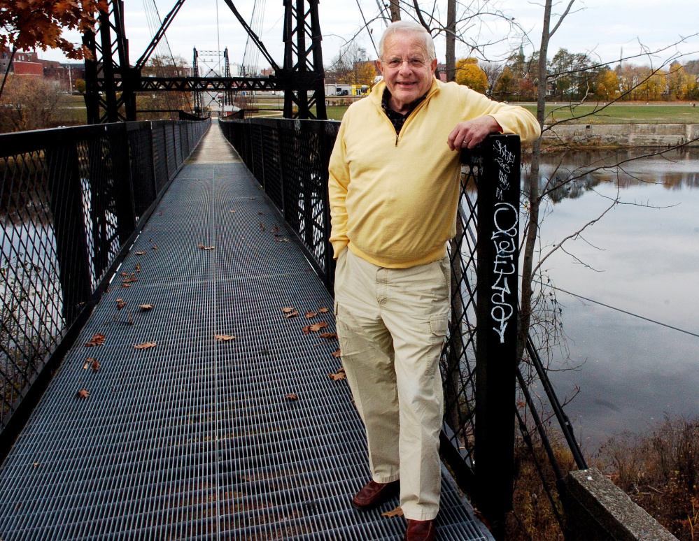 Author Earl Smith stands beside the Two Cent Bridge on Wednesday at Head of Falls in Waterville, alongside the Kennebec River. Smith has written a book of historical fiction, "Head of Falls," which is about teen-age Lebanese girl who lives on the riverfront.