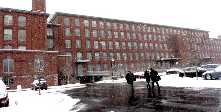 People enter the Hathaway Creative Center in Waterville on Monday. City councilors are considering allowing a tax increment financing agreement to be transferred to a future new owner of the building, which is for sale.