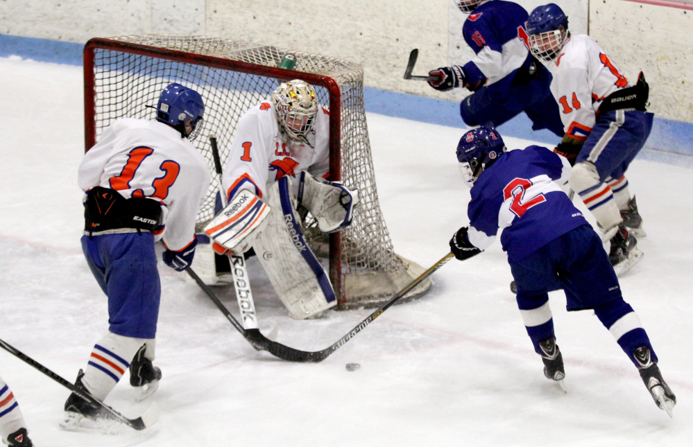 Lawrence/Skowhegan goalie Curtis Martin turns away a scoring opportunity from Mt. Ararat forward Tyler Lacasio during the first period of a game last February in Winslow. Martin returns to backstop the Bandits once again.