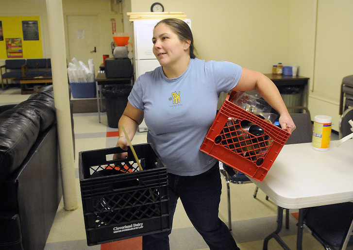 Augusta Community Warming Center director Deidrah Stanchfield organizes items Dec. 14, 2015, at the center at St. Mark's Parish Hall at 9 Pleasant St.