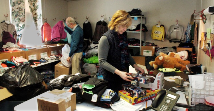 At the Maine Children's Home for Little Wanderers in Waterville, Director of Development Steve Mayberry and Christmas Program Director Cristen Sawyer sort through kids toys and clothing on Tuesday. "We have had an awesome response of donations of clothes, toys and money from really generous people," Sawyer said. Mayberry added that 1,759 kids will receive gifts this year.