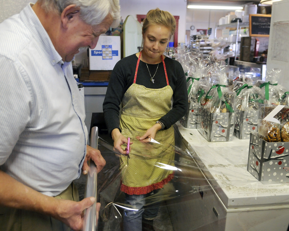 Jenya Sakoeva and Bill Beaulier wrap gift baskets to ship Wednesday at the Apple Shed Bakery in Readfield.