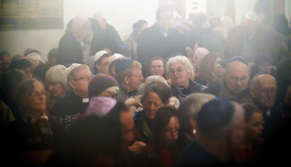 People gather at an interfaith service of healing Friday evening at Beth Israel Congregation in Waterville in response to swastika having been painted on a rock at the city-owned Quarry Road Recreation Area.