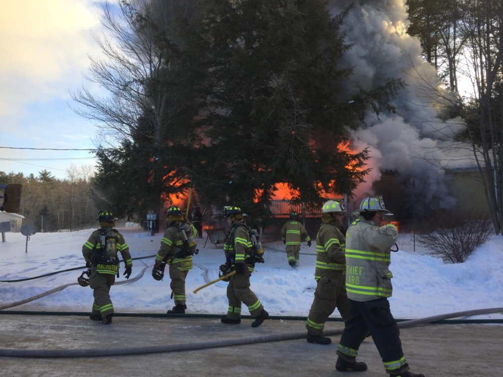 Contributed photo
Firefighters work Tuesday at a fire scene at 15 Blue Rock Road in Monmouth, where a mobile home was destroyed.