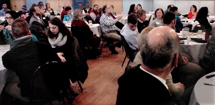 Jim Peacock, center, makes a point during a talk Thursday by Tom Dowd about the need for businesses to attract and retain young employees, known as millennials, during a breakfast meeting at Thomas College in Waterville.