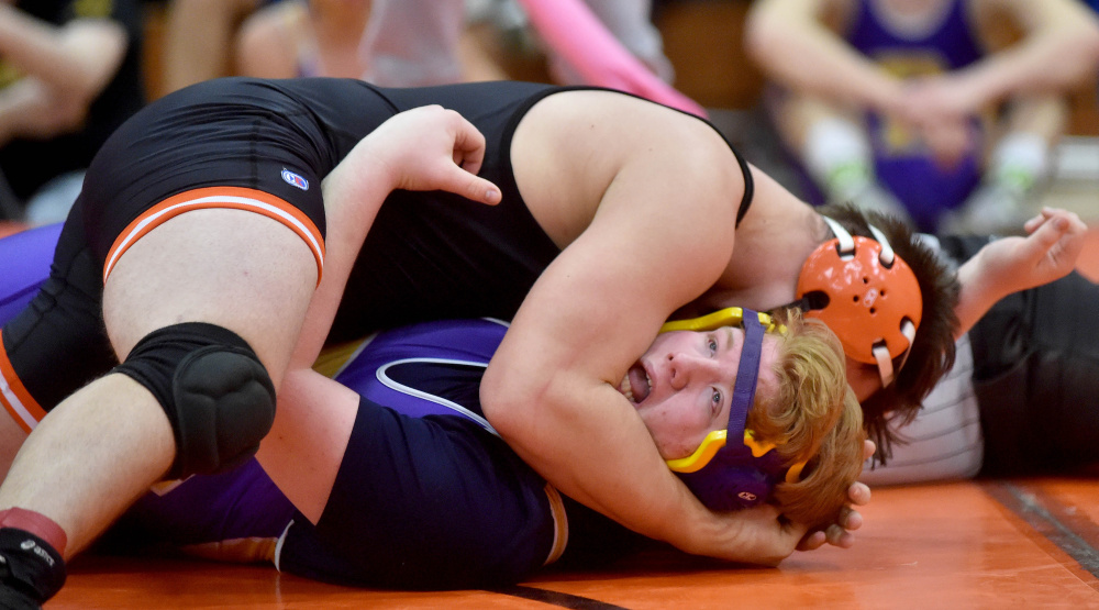 Skowhegan's John Tucker, top, battles with Bucksport's Sam Murphy in the 220-pound weight class Saturday in Skowhegan.