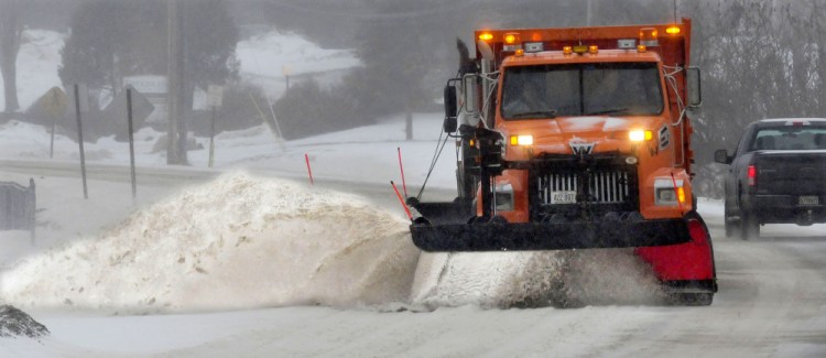 Waterville Public Works employee Dan Wilson clears snow while driving a department plow truck during the storm in Waterville on Tuesday.