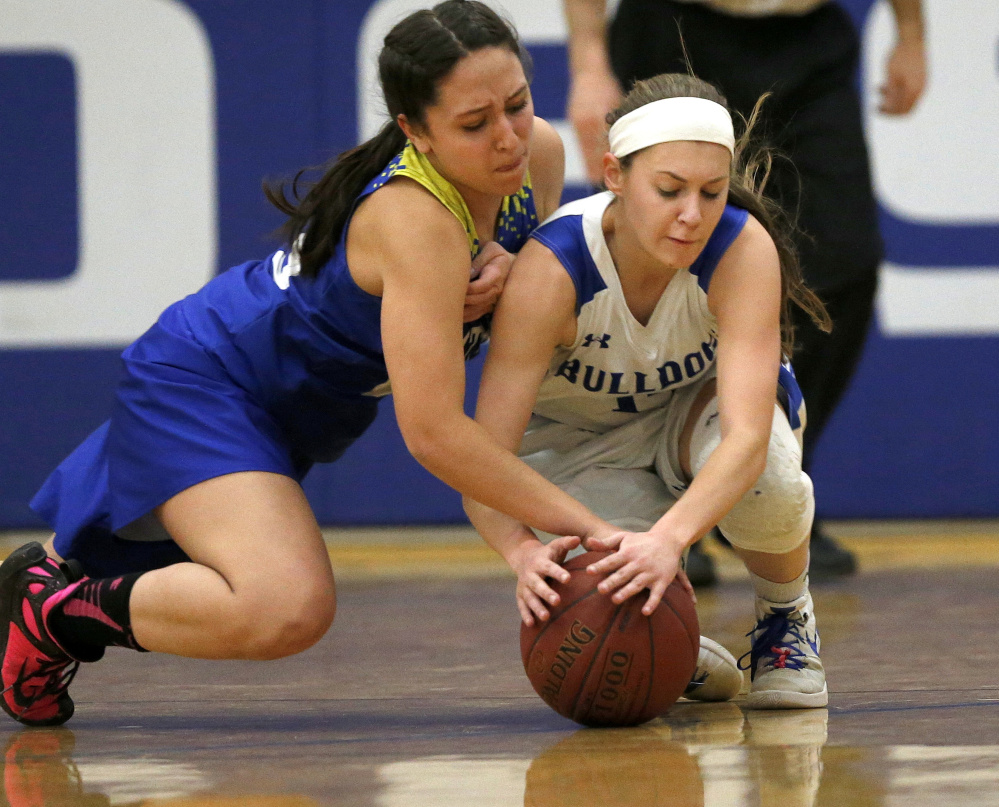 Mt Abram sophomore, left, Summer Ross and Madison junior Sydney LeBlanc fight for possession of the ball during the first half of a Mountain Valley Conference game Tuesday night.