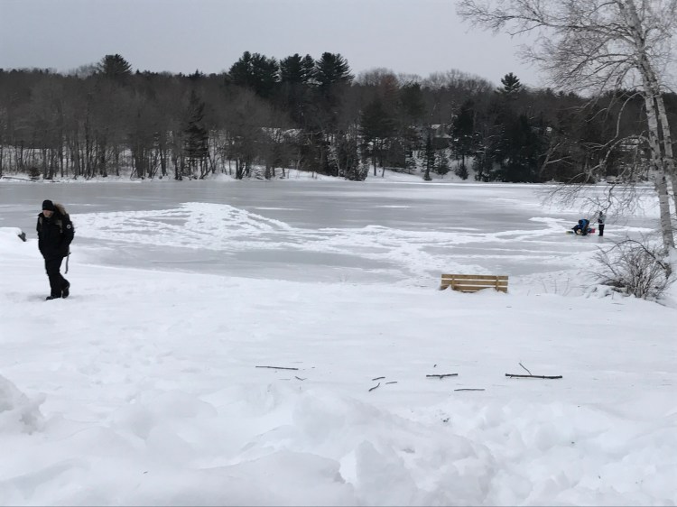 Authorities respond Saturday to Messalonskee Lake in Oakland, where a snowmobiler fell through the ice and later died. (Staff photo by Madeline St. Amour)