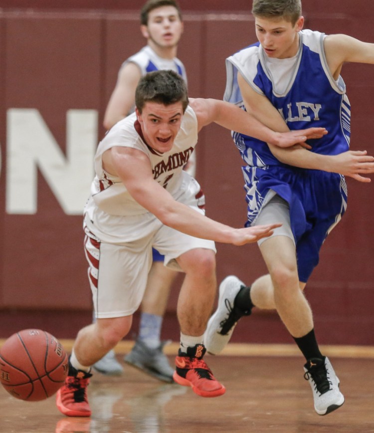 Richmond's Matt Holt and Valley's Joshua Brown for a loose ball during an East/West Conference game Wednesday night in Richmond.