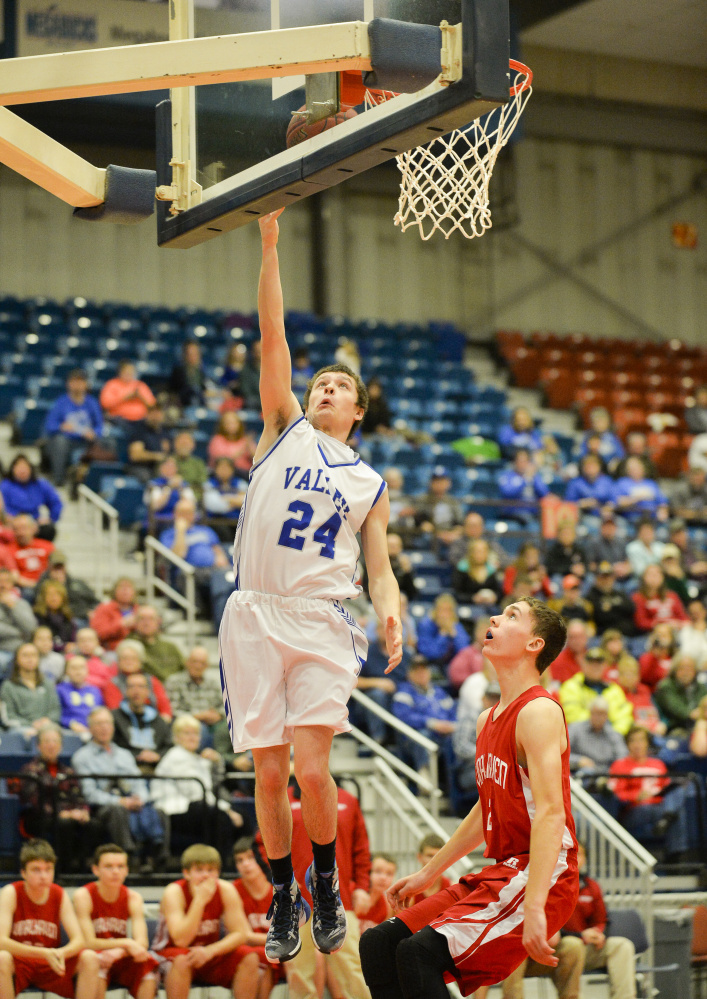 Valley's Austin Cates goes up for a basket past ahead of Vinalhaven defender Mikael Stone in the first half of a Class D South quarterfinal game Saturday in Augusta.