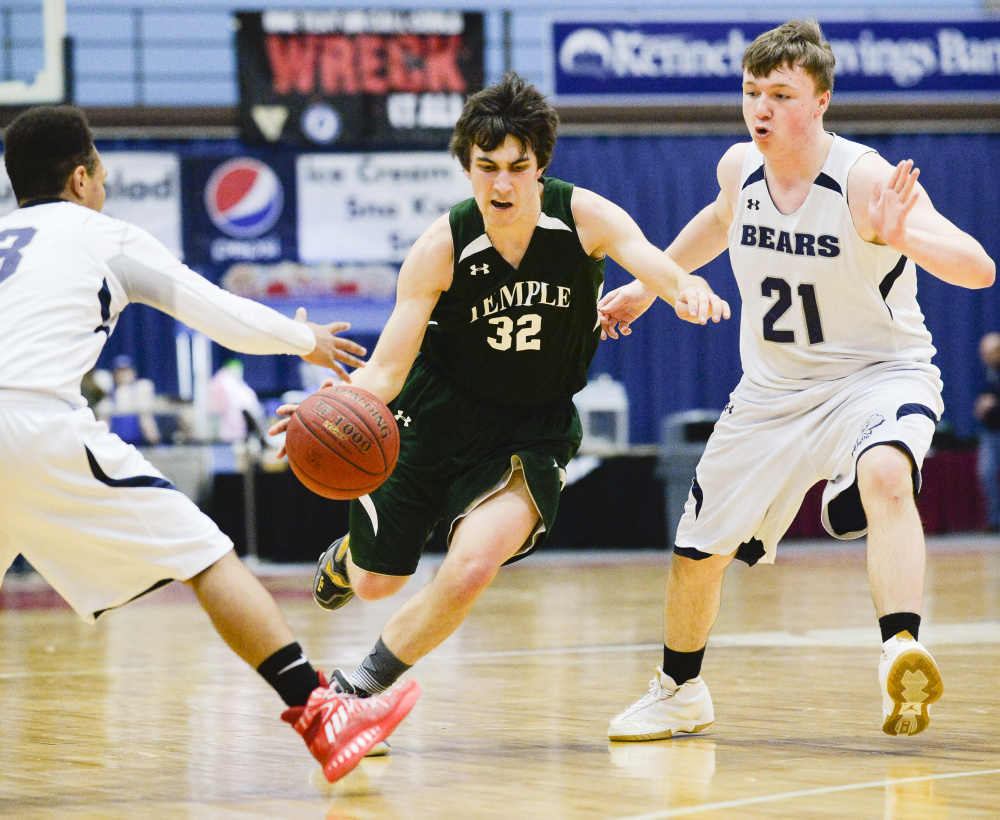 Temple's Nathaniel Wells dribbles between A.R. Gould defenders Tyrese Collins, left, and Adam Black in the second half of a Class D South quarterfinal game Saturday morning at the Augusta Civic Center.