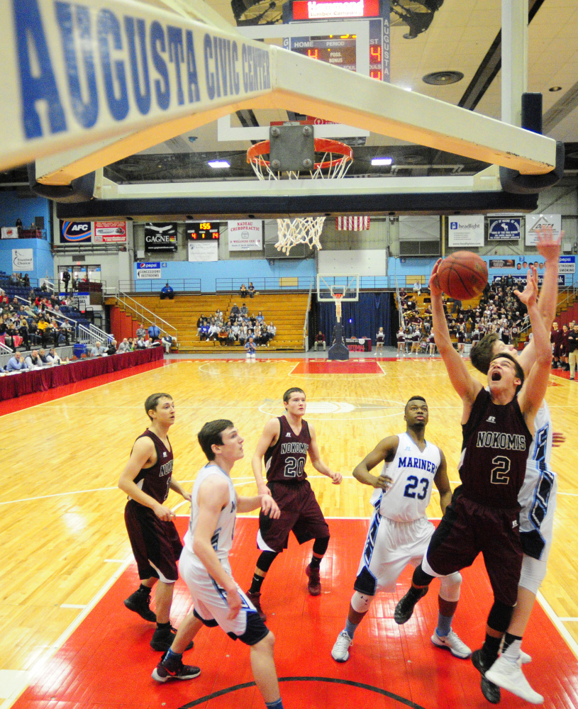 Staff photo by Joe Phelan
Nokomis' Joshua Smestad and Oceanside's Cooper Wirkala go for a rebound during a Class A North quarterfinal game Saturday at the Augusta Civic Center.