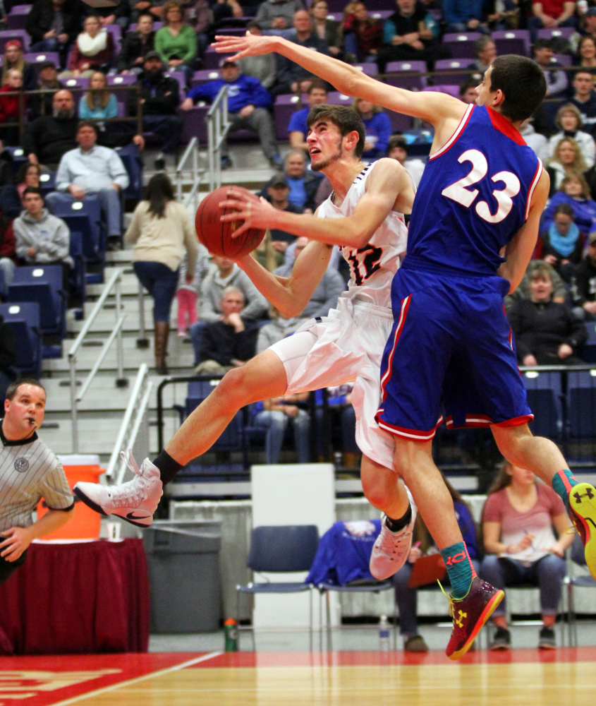 Gardiner Area High School's Connor McGuire gets fouled by Messalonskee High School's Griffin Tuttle on a drive to the basket in the first half of a Class A North quarterfinal in Augusta on Saturday night.