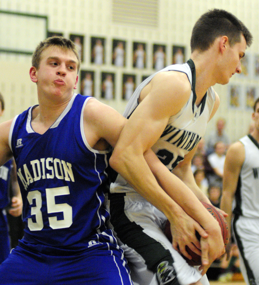 Madison's Max Shibley, left, fights for a rebound with Winthrop's Garrett Tsouprake during a game earlier this season in Winthrop.