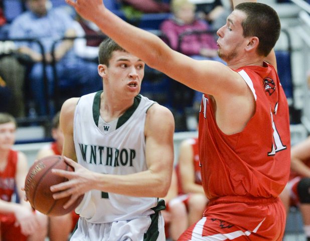 Winthrop's Bennett Brooks, left, looks through the defense of Wiscasset's Nathanial Woodman for a teammate to whom he can pass the ball early in their Class C South quarterfinal Monday in Augusta.