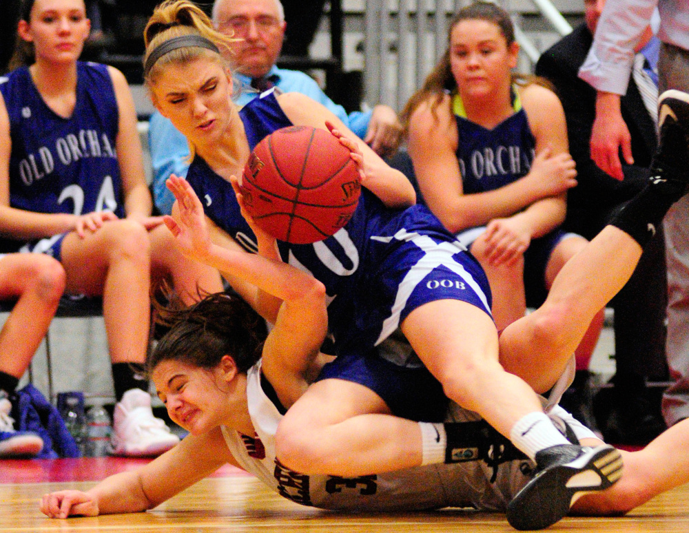 Old Orchard's Victoria Niedzwiecki, top, and Richmond's Mackenzie Abbott scramble for a loose ball during a Class C semifinal game Thursday at the Augusta Civic Center.