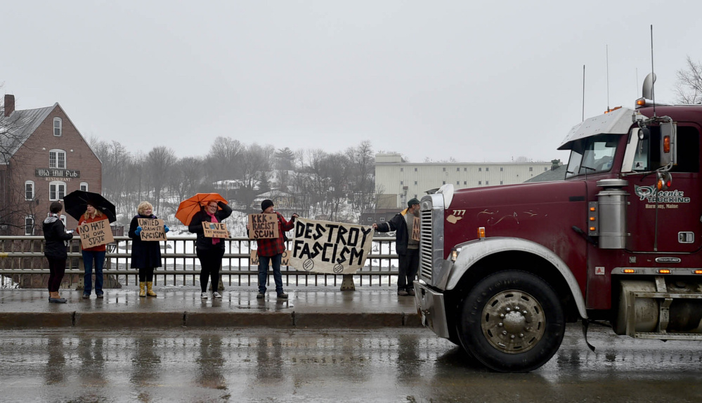 Protesters stand on the Margaret Chase Smith Bridges in Skowhegan on Saturday to protest the Ku Klux Klan.