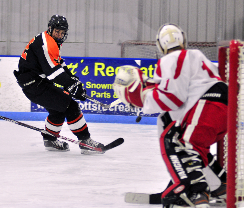 Cony/Hall-Dale/Monmouth goalie Dalton Bowie keeps an eye on Gardiner's Joe Clark during a game earlier this month at the Camden National Bank Ice Vault in Hallowell. Bowie and the Rams will play Edward Little in an A North quarterfinal game tonight in Hallowell.