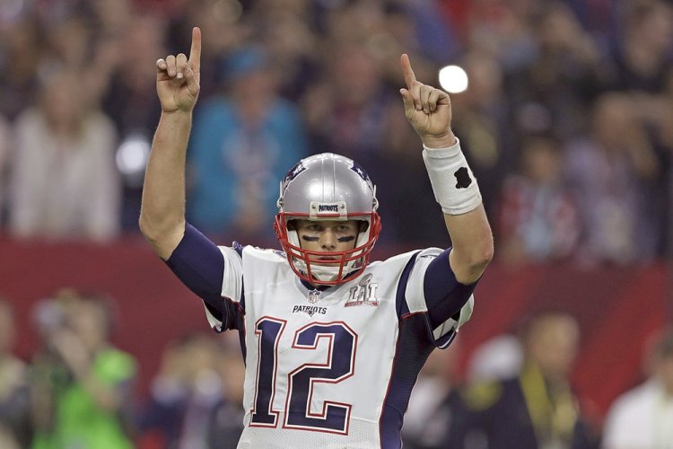New England Patriots' Tom Brady raises his arms after a touchdown, during the second half of Super Bowl 51 Sunday. 