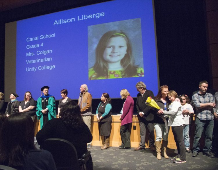 A prospective veterinarian, Oxford-Cumberland Canal Elementary School pupil Allison Liberge gets a kiss from her mother, Ashley Clark, after receiving her Maine College Aspirations Scholarship Wednesday during festivities at the Westbrook Performing Arts Center.