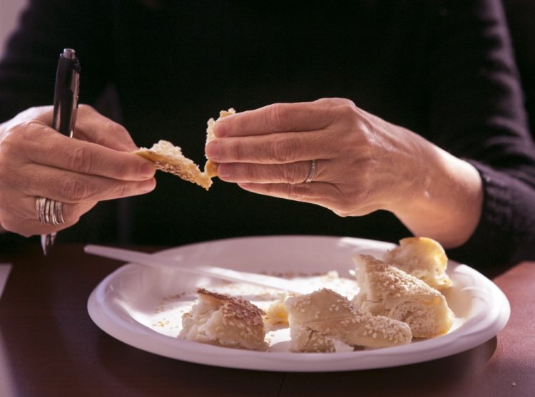 Alison Pray, founder and co-owner of Standard Baking Co. in Portland, taste-tests bagels at the Portland Press Herald.