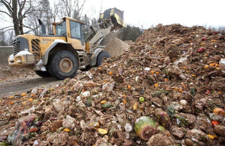 An attachment on an excavator grinds up food waste at Agri-Cycle Energy in Exeter, a sister company of Exeter-Agra Energy. Food waste collected in South Portland and Scarborough will go to ecomaine in Portland and then be shipped to Exeter-Agra.