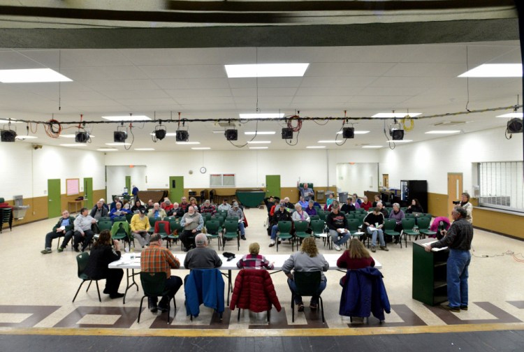 Anson residents gather on Saturday at Carrabec High School to vote on articles during Town Meeting in Anson.