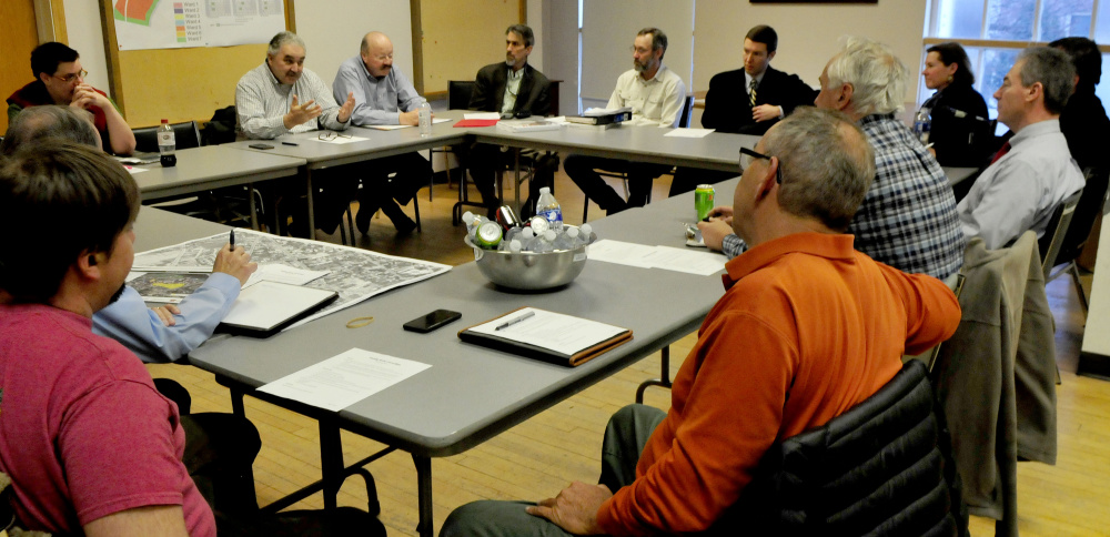 Paul Ureneck, director of commercial real estate for Colby College and Elm City LLC, left, addresses members of the Waterville Parking Study Committee Wednesday evening during the group's inaugural meeting.