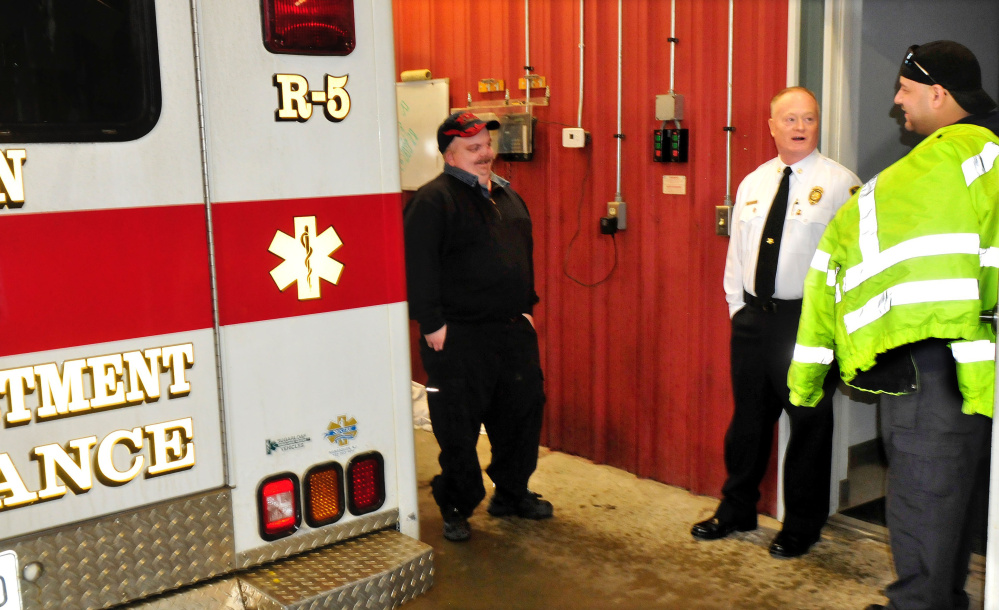 Clinton Fire Chief Gary Petley, center, is retiring from a career as a firefighter, having been chief of his department for 25 years. Petley spoke Wednesday with Travis Cousins, left, and Travis Fillmore in the rescue bay area in the fire station.