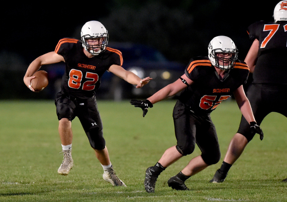 Skowhegan quarterback Garrett McSweeney (82) rushes for some yards against Gardiner in a PTC B game last season in Skowhegan.